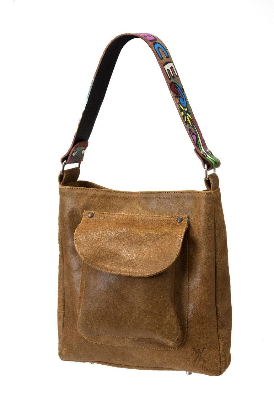 Brown leather shoulder bag with a colorful strap on a white background