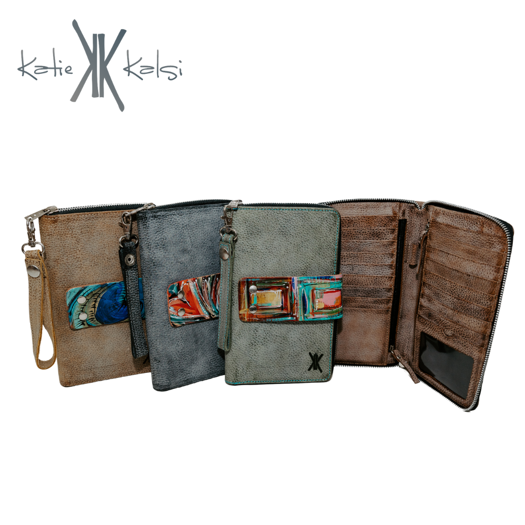 Large zipper wallet, cuff included. Snap on hand-painted interchangeable cuff, zipper closure with clip on wristlet. Includes 17 card holders, clear ID holder, two zipper pockets, two pockets on each side with a divider and an outside pocket! Dimensions: 5.5” x 9” x 1” 